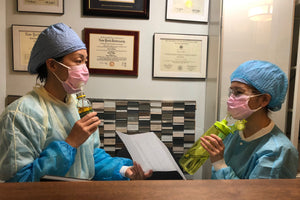 Dr. Wong and Raquel wearing Suck It Sockets in medical masks